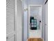 Hallway view into a bathroom with storage shelves and a double vanity at 4419 Gaston St, Spring Hill, FL 34607