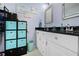 Bathroom with double vanity, black granite countertop, and decorative storage at 4419 Gaston St, Spring Hill, FL 34607
