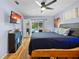 Stylish bedroom with a pool view, ceiling fan, and decorative storage at 4419 Gaston St, Spring Hill, FL 34607