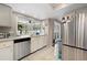 Charming kitchen with stainless steel appliances, white cabinets, and an abundance of natural light at 4419 Gaston St, Spring Hill, FL 34607