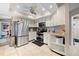 Bright kitchen featuring white cabinets, stainless steel appliances, and tile flooring with an open layout at 4419 Gaston St, Spring Hill, FL 34607