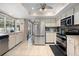 Well-lit kitchen with stainless steel appliances, white cabinets, and a convenient layout for cooking at 4419 Gaston St, Spring Hill, FL 34607