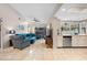 Inviting living room with tile flooring, a ceiling fan, and comfortable furniture, seamlessly connected to kitchen at 4419 Gaston St, Spring Hill, FL 34607