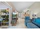 Inviting living area boasts tile flooring, a comfortable blue chair and ottoman, and access to a plant-filled patio at 4419 Gaston St, Spring Hill, FL 34607
