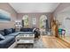 Comfortable living room featuring wood floors, neutral walls and arched windows with backyard views at 4419 Gaston St, Spring Hill, FL 34607