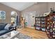Cozy living room with vaulted ceilings, wood floors and an arched window with natural light at 4419 Gaston St, Spring Hill, FL 34607