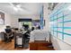 Bright home office featuring hardwood floors, comfortable seating, a printer, and ample workspace for productivity at 4419 Gaston St, Spring Hill, FL 34607