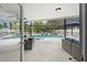 Relaxing outdoor space with a screened pool, stylish seating, and dining area at 4419 Gaston St, Spring Hill, FL 34607