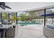 Relaxing outdoor space with a screened pool, stylish seating, and an outdoor grill at 4419 Gaston St, Spring Hill, FL 34607