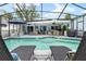 Enjoy the large screened-in pool area with lounge chairs and stylish seating at 4419 Gaston St, Spring Hill, FL 34607
