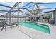 Enjoy the large screened-in pool area with lounge chairs and dining space at 4419 Gaston St, Spring Hill, FL 34607