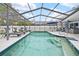 Enjoy the large screened-in pool area with lounge chairs and inviting, crystal-clear water at 4419 Gaston St, Spring Hill, FL 34607