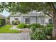The home's backyard with covered, screened patio, surrounded by lush tropical plants, and stone pavers at 4926 Pennecott Way, Wesley Chapel, FL 33544