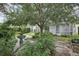 Lush backyard featuring a stone fountain, manicured landscaping, and ample space for relaxation at 4926 Pennecott Way, Wesley Chapel, FL 33544