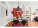 Dining area showcasing modern decor, a glass table, and unique artwork at 4926 Pennecott Way, Wesley Chapel, FL 33544