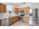 Well-equipped kitchen featuring stainless steel appliances, ample cabinet space, and bright countertops at 4926 Pennecott Way, Wesley Chapel, FL 33544