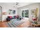 Bright living room with modern furniture, ceiling fan and sliding glass doors to outdoor space at 4926 Pennecott Way, Wesley Chapel, FL 33544