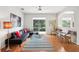 Bright living room featuring hardwood floors, comfortable seating, and natural light at 4926 Pennecott Way, Wesley Chapel, FL 33544