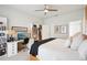 Spacious bedroom features a ceiling fan, a desk, bookshelves, and a soothing color scheme at 4926 Pennecott Way, Wesley Chapel, FL 33544