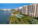 Aerial view of waterfront condos with a pool and landscaped grounds by the water at 4953 Bacopa S Ln # 205, St Petersburg, FL 33715