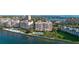Aerial view of condominiums with a pool, water views, and well-manicured grounds at 4953 Bacopa S Ln # 205, St Petersburg, FL 33715
