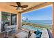 Relaxing balcony with comfortable seating, ceiling fan, and stunning views of the bay and pool at 4953 Bacopa S Ln # 205, St Petersburg, FL 33715