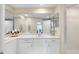 Bright bathroom featuring double vanity, large mirror, and walk-in shower at 4953 Bacopa S Ln # 205, St Petersburg, FL 33715