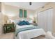 Comfortable bedroom with a white bed, green bedside table, and soft, neutral walls at 4953 Bacopa S Ln # 205, St Petersburg, FL 33715