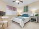 Cozy bedroom showcasing a white bed, turquoise accents, and a ceiling fan at 4953 Bacopa S Ln # 205, St Petersburg, FL 33715