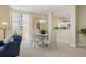 Stylish dining area with contemporary furnishings and view to kitchen area at 4953 Bacopa S Ln # 205, St Petersburg, FL 33715