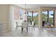 Dining area with view to balcony with outdoor seating at 4953 Bacopa S Ln # 205, St Petersburg, FL 33715
