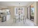 Bright dining area features a glass table, modern chandelier, and access to the balcony at 4953 Bacopa S Ln # 205, St Petersburg, FL 33715