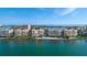 Exterior of condominiums features a pool, beach, and beautiful water views at 4953 Bacopa S Ln # 205, St Petersburg, FL 33715