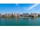 Waterfront condos with beautiful landscaping, sandy beach, and blue skies reflected in the water at 4953 Bacopa S Ln # 205, St Petersburg, FL 33715