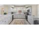 Kitchen featuring white cabinets and marble backsplash at 4953 Bacopa S Ln # 205, St Petersburg, FL 33715