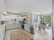 Kitchen leading to dining area with access to balcony at 4953 Bacopa S Ln # 205, St Petersburg, FL 33715