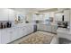 Updated kitchen with stainless steel appliances, white cabinets, and water view at 4953 Bacopa S Ln # 205, St Petersburg, FL 33715