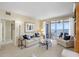 Open living room featuring comfortable seating and floor-to-ceiling glass doors to balcony with water view at 4953 Bacopa S Ln # 205, St Petersburg, FL 33715