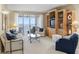 Spacious living room with water views, balcony access, and custom built-in shelving at 4953 Bacopa S Ln # 205, St Petersburg, FL 33715