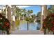 Scenic view of the pond framed by elegant columns and lush greenery creating a tranquil outdoor space at 4953 Bacopa S Ln # 205, St Petersburg, FL 33715