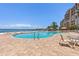 A resort-style swimming pool with a poolside seating area overlooking the bay at 4953 Bacopa S Ln # 205, St Petersburg, FL 33715