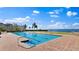 Inviting community pool with clear water, lounge chairs, and waterfront views at 4953 Bacopa S Ln # 205, St Petersburg, FL 33715