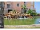 Exterior view of a luxurious water feature with plants in front of building at 4953 Bacopa S Ln # 205, St Petersburg, FL 33715