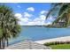 Picturesque view of bay framed by mature trees and glimpses of the coastline beyond at 4953 Bacopa S Ln # 205, St Petersburg, FL 33715