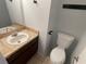 Half bath features single vanity with marble countertop and neutral paint at 5042 Terrace Village Ln, Tampa, FL 33617