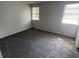Bedroom featuring neutral paint, two windows with blinds, and carpeted floors at 5042 Terrace Village Ln, Tampa, FL 33617