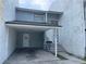 Two-story home featuring a carport for convenient parking and covered access at 5042 Terrace Village Ln, Tampa, FL 33617