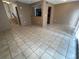 Open concept living room featuring neutral paint and tile floors, with easy kitchen access at 5042 Terrace Village Ln, Tampa, FL 33617