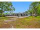 Large backyard showcasing the screened-in pool and ample space at 538 Bamboo Ln, Clearwater, FL 33764