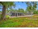 Spacious backyard with screened-in pool, patio, and fire pit at 538 Bamboo Ln, Clearwater, FL 33764